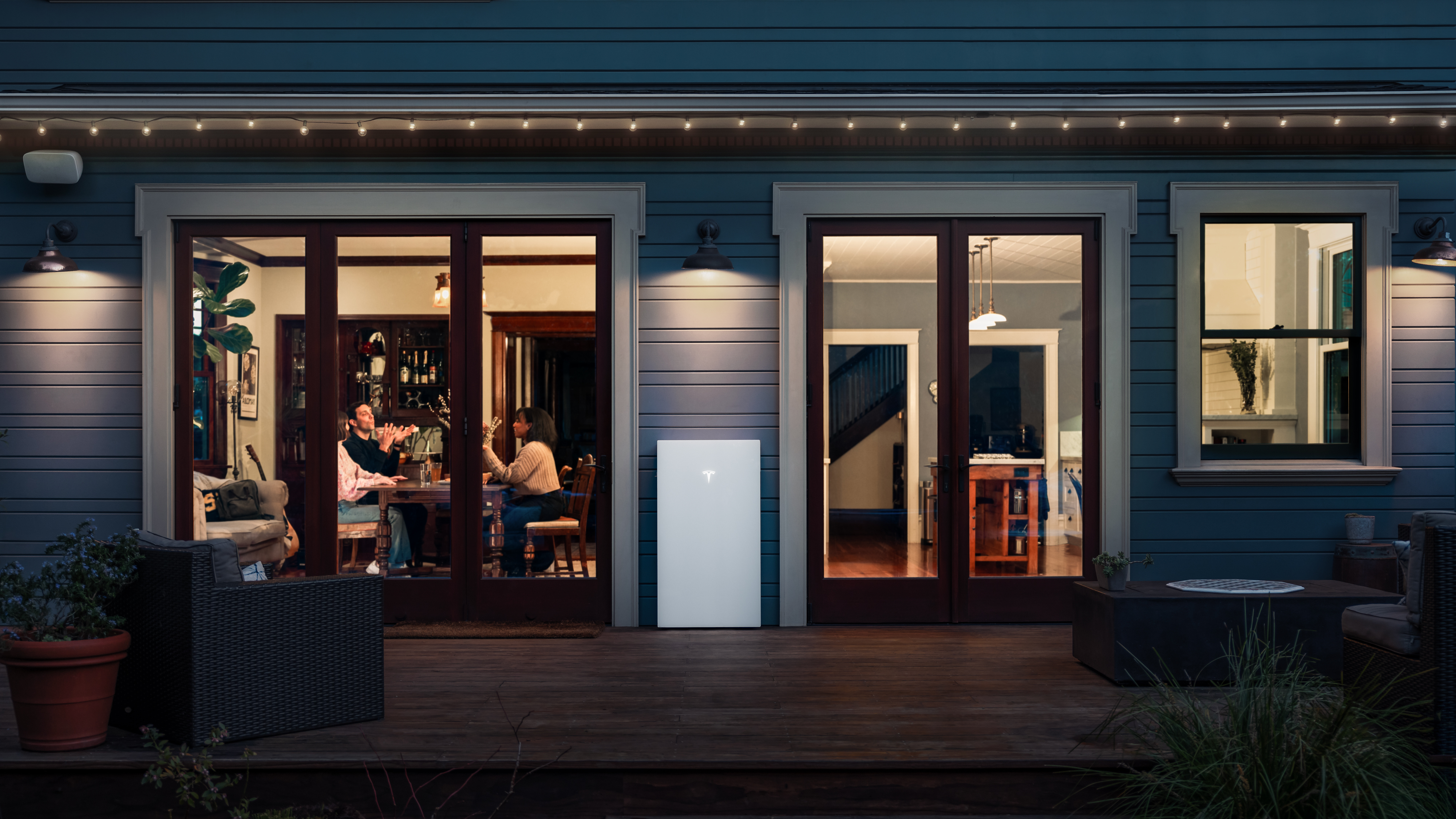 Tesla Powerwall installed outside home at night