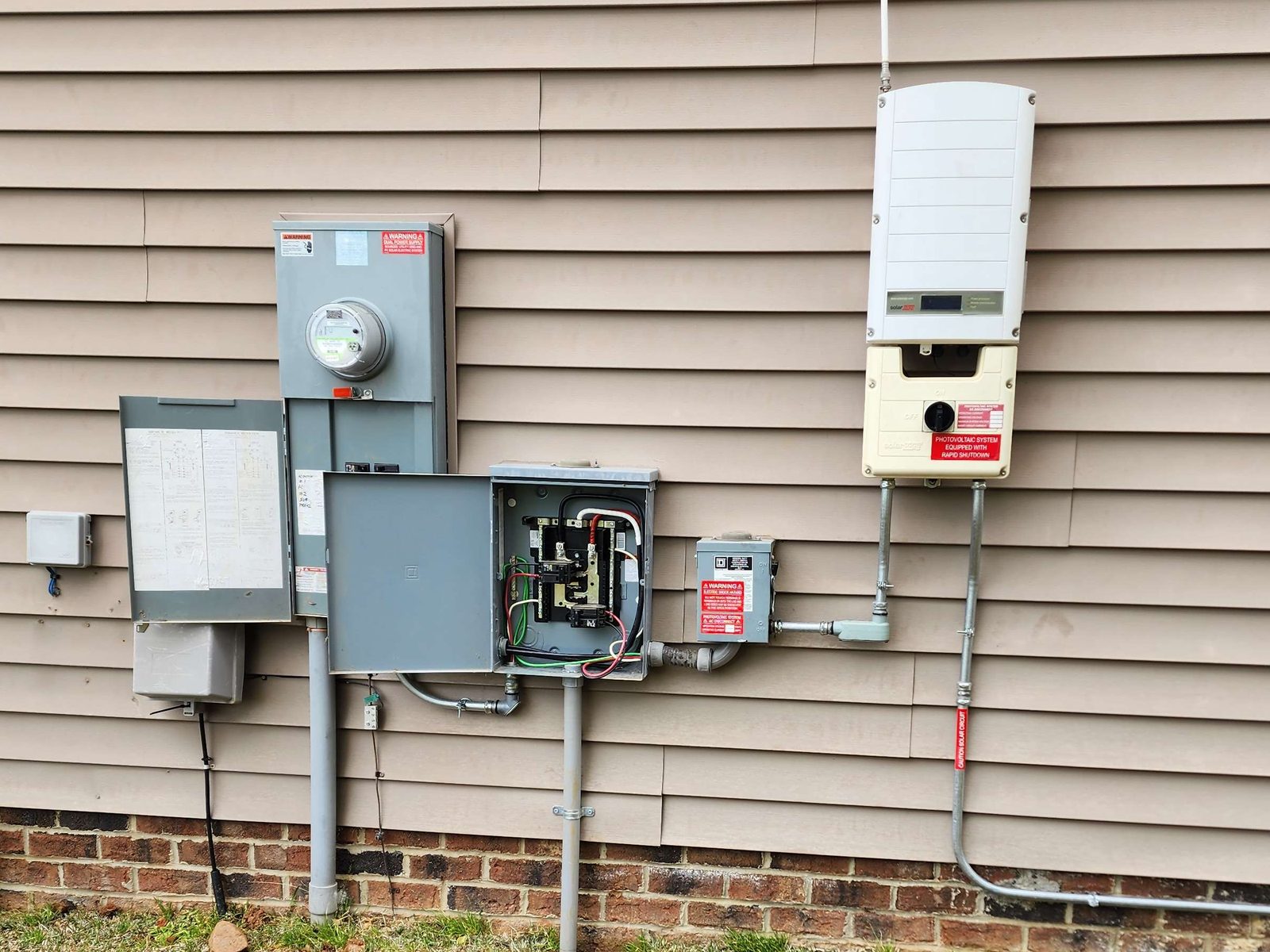 New meter, panel and disconnects installed on the side of a home