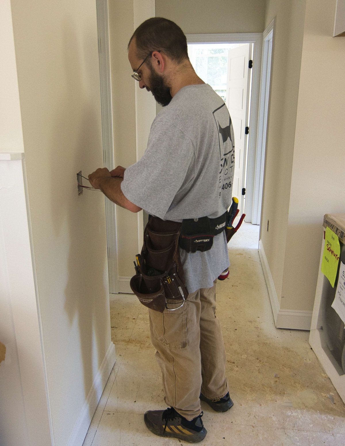 Cow Dog electrician wiring a switch