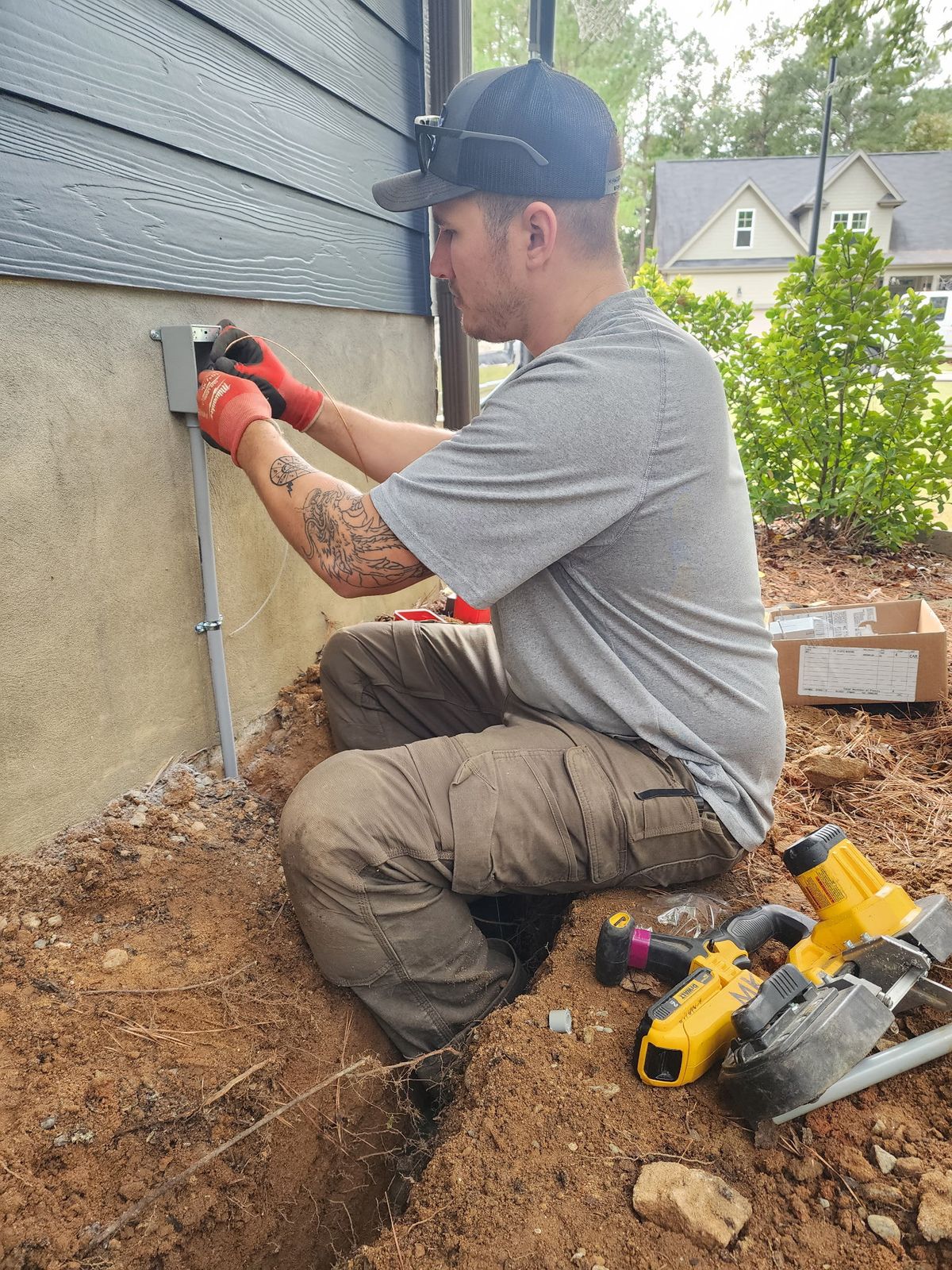 Cow Dog electrician running an underground feed to a house