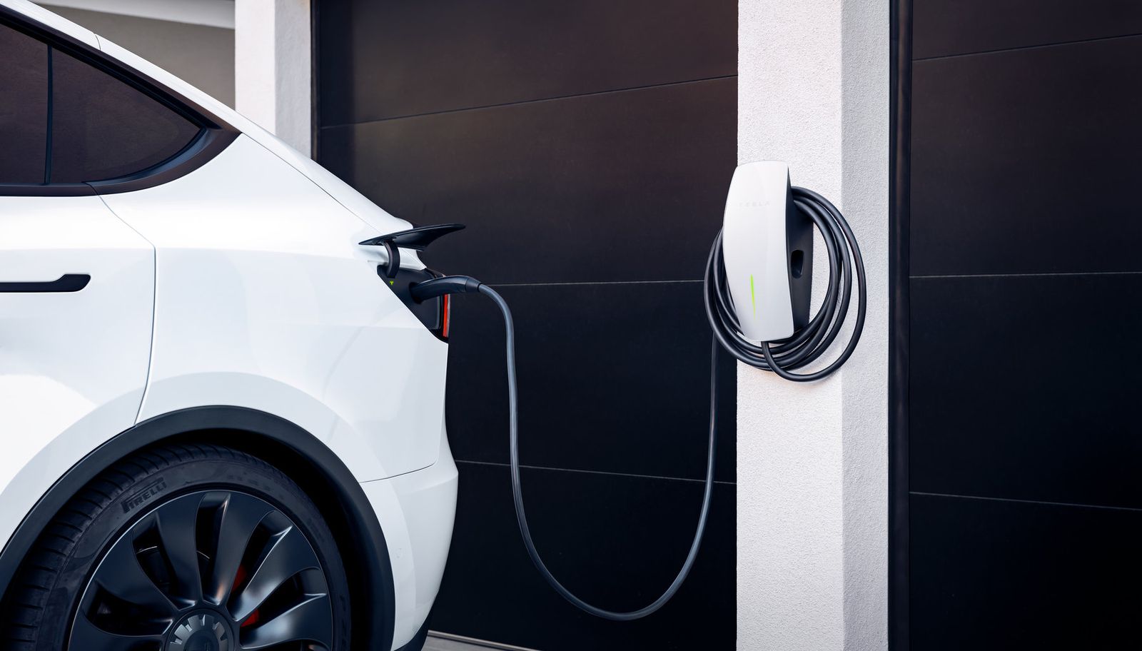 Tesla Wall Connector charging a car